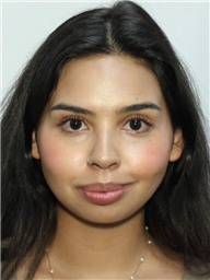 A young woman with long dark hair and a slight smile is looking directly at the camera.