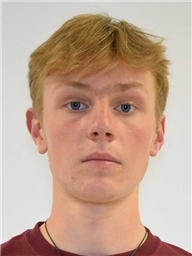 A young person with light brown hair and blue eyes is looking directly at the camera.
